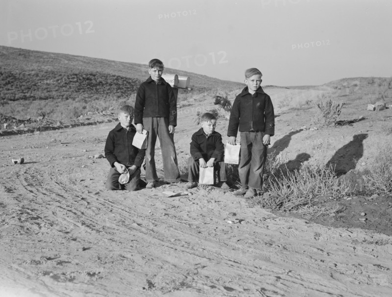 Boys wait for school bus in the morning. Malheur County, Oregon.