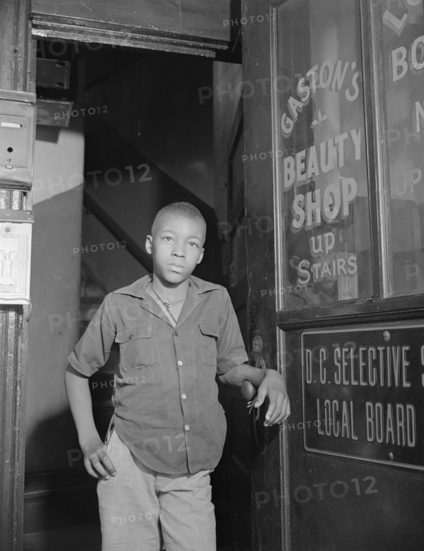 Washington, D.C. Youth waiting for a newspaper delivery truck.