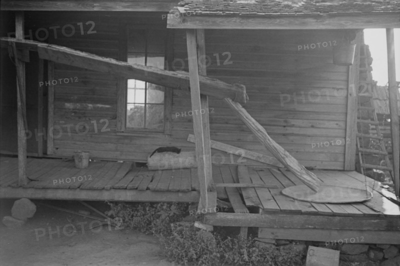 Porch of a sharecropper's cabin, Hale County, Alabama.
