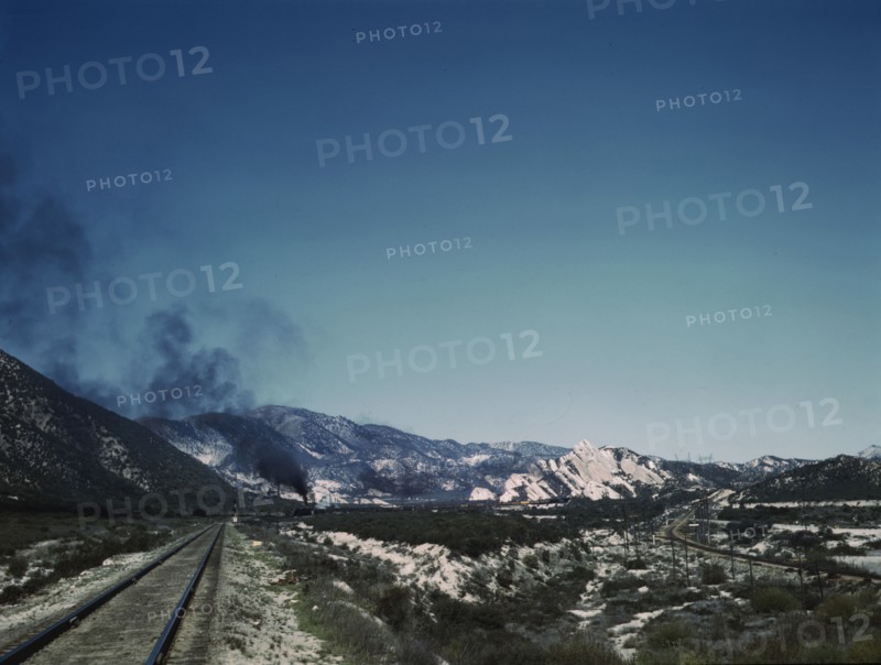Freight train going up Cajon Pass through the San Bernardino Mountains, Cajon, Calif., 1943. Creator: Jack Delano.