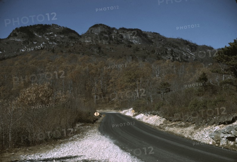 The road along the Skyline Drive, with a light snowfall in the rocks beside, Virginia, ca. 1940. Creator: Jack Delano.