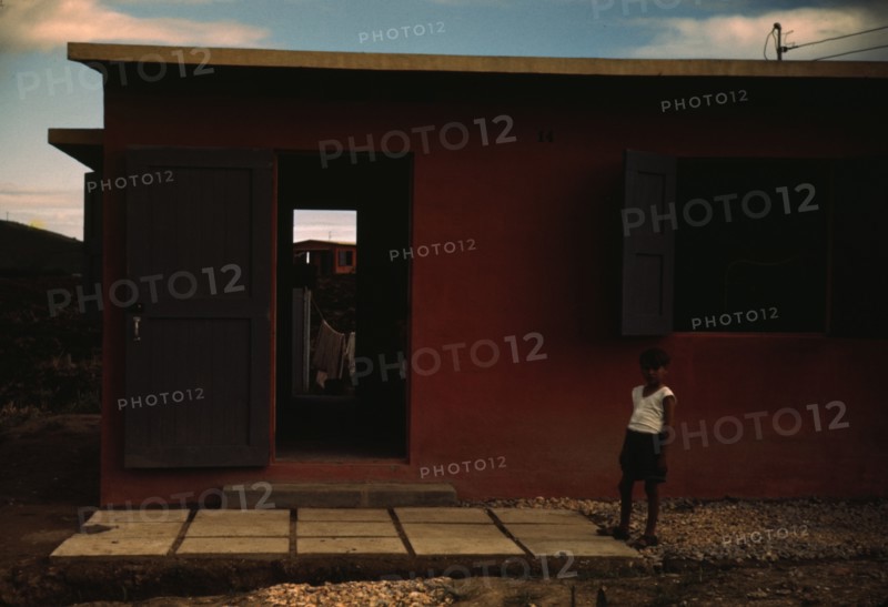 Child of an FSA - R.R. borrower? in front of their house, Puerto Rico, 1941 or 1942. Creator: Jack Delano.