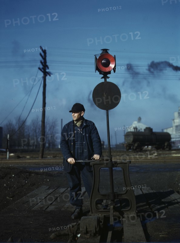 Daniel Senise throwing a switch while at work in an Indiana Harbor Belt Line railroad yard, 1943. Creator: Jack Delano.