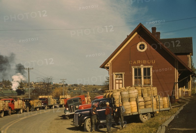 Trucks outside of a starch factory, Caribou, Aroostook County, Maine. , 1940. Creator: Jack Delano.