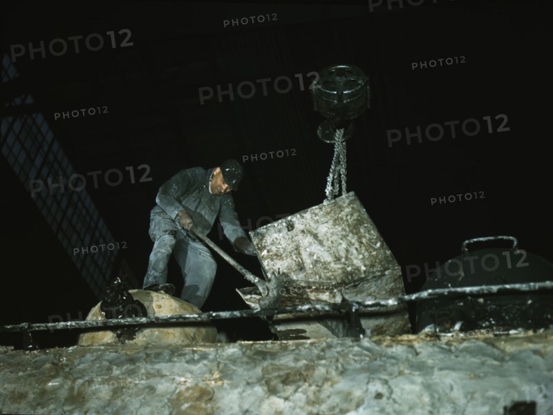 Spreading asbestos mixture on boiler of a locomotive, C & NW RR, 40th Street locomotive shops, 1942. Creator: Jack Delano.