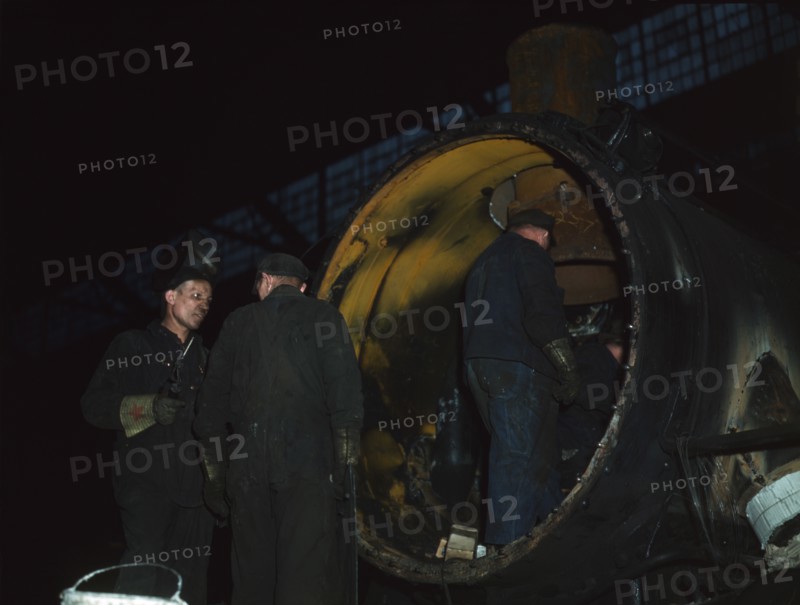 Working on the boiler of a locomotive at the 40th Street shops of the C & NW RR, Chicago, Ill., 1942 Creator: Jack Delano.