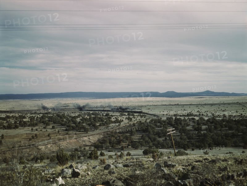 West-bound passenger train going around a curve on the Atchison..., near Gleed, Arizona, 1943. Creator: Jack Delano.