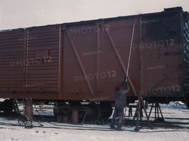 Painting a car at the repair or "rip" tracks at North Proviso(?), C & NW RR, Chicago, Ill., 1942. Creator: Jack Delano.