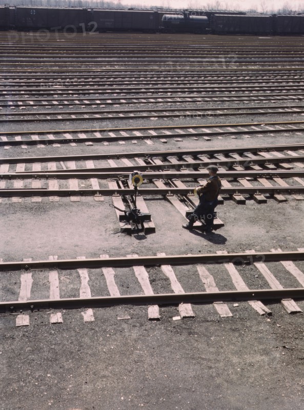 Switchman throwing a switch a C and NW RR's Proviso yard, Chicago, Ill., 1943. Creator: Jack Delano.