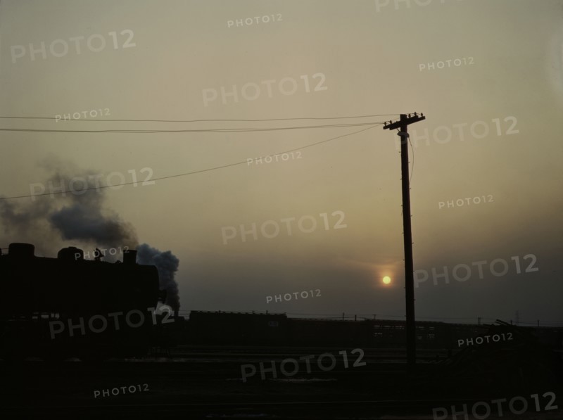 View in a departure yard at C & NW RR's Proviso (?) yard at twilight, Chicago, Ill., 1942. Creator: Jack Delano.