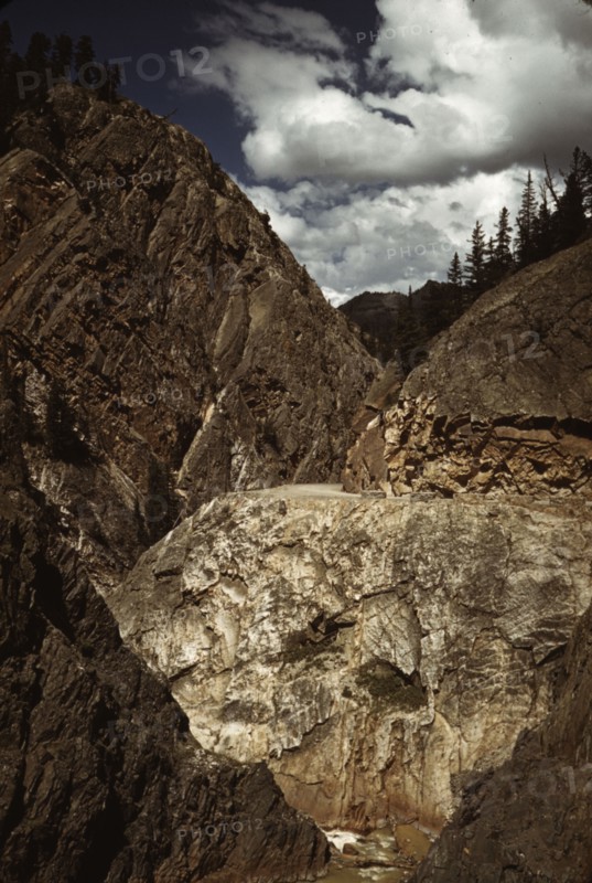 Million dollar highway [U.S. 550] is cut through massive rocks in Ouray County, Colorado, 1940. Creator: Russell Lee.