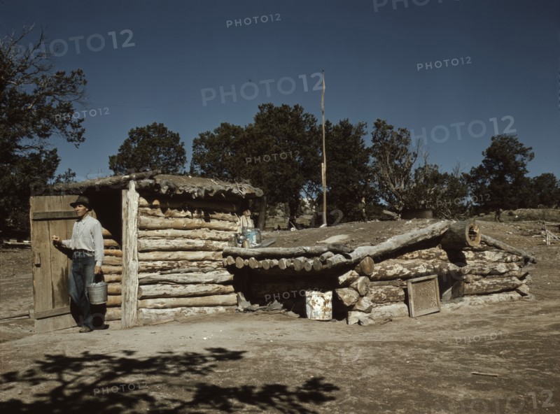 Mr. Leatherman, homesteader, coming out of his dugout home, Pie Town, New Mexico, 1940. Creator: Russell Lee.