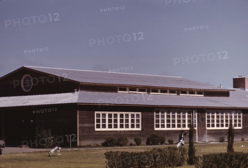 Boys flying a kite in front of the community center, FSA camp, Robstown, Tex., 1942. Creator: Arthur Rothstein.