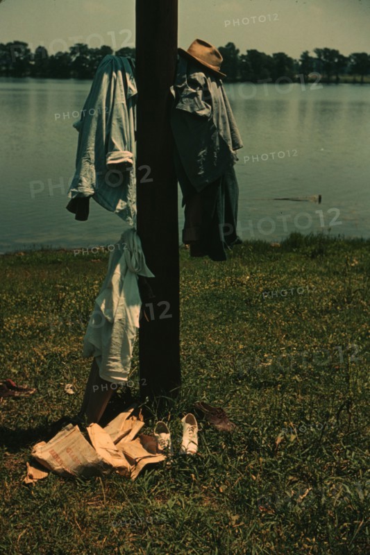 Clothes of swimmers hanging on a telegraph pole, Lake Providence, La., 1940. Creator: Marion Post Wolcott.