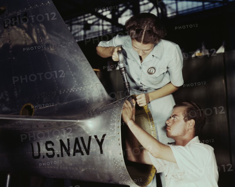 Mrs. Virginia Davis, a riveter in the assembly and repair department of the Naval air base..., 1942. Creator: Howard Hollem.