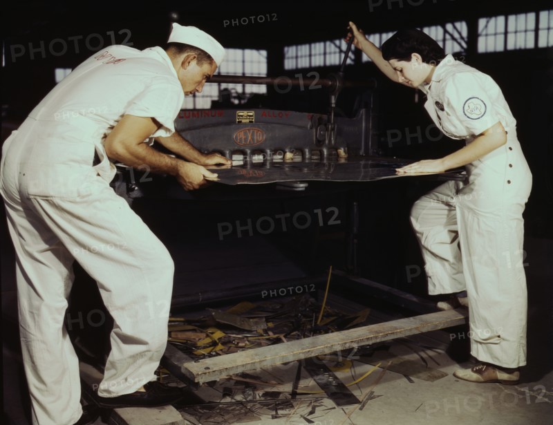 Learning to work a cutting machine, these two NYA employees...Corpus Christi, Texas, 1942. Creator: Howard Hollem.