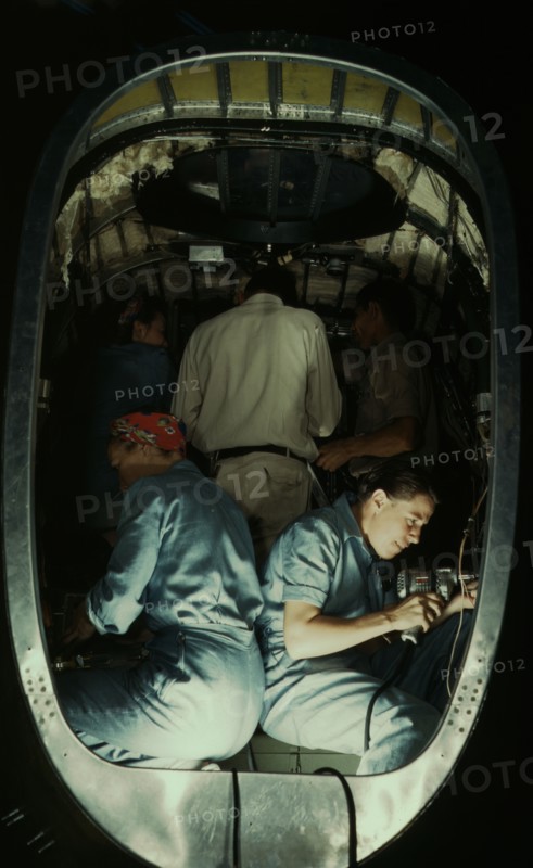 Working inside fuselage of a Liberator Bomber, Consolidated Aircraft Corp., Fort Worth, Texas, 1942. Creator: Howard Hollem.