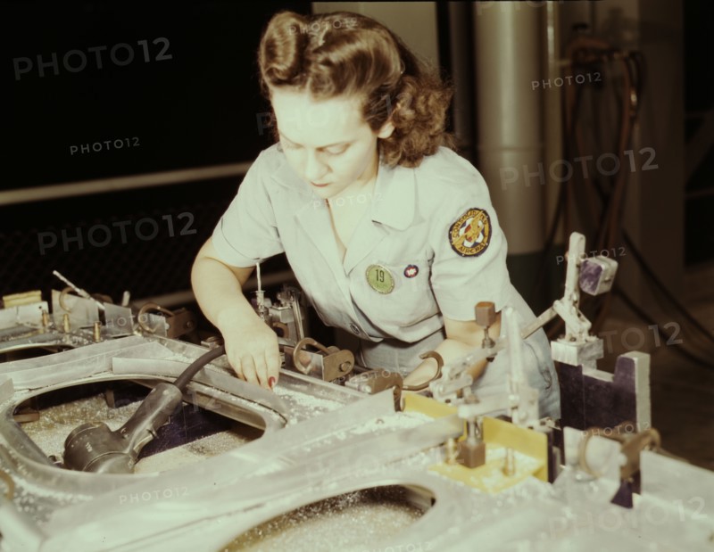 Drilling a wing bulkhead for a transport plane at the Consolidated Air..., Fort Worth, Texas, 1942. Creator: Howard Hollem.