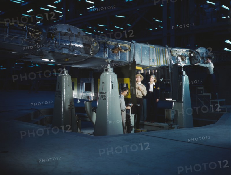 Working on wing of Consolidated Liberator..., Consolidated Aircraft Corp., Fort Worth, Texas, 1942. Creator: Howard Hollem.