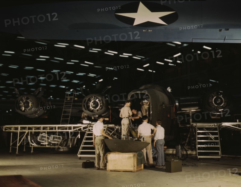 Getting a nose door ready to put on a C-87...Consolidated Aircraft Corp..., Fort Worth, Texas, 1942. Creator: Howard Hollem.