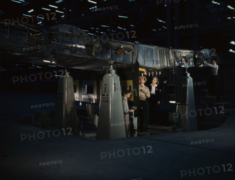 Working on the wing center section at the Consolidated Aircraft Corp..., Fort Worth, Texas, 1942. Creator: Howard Hollem.