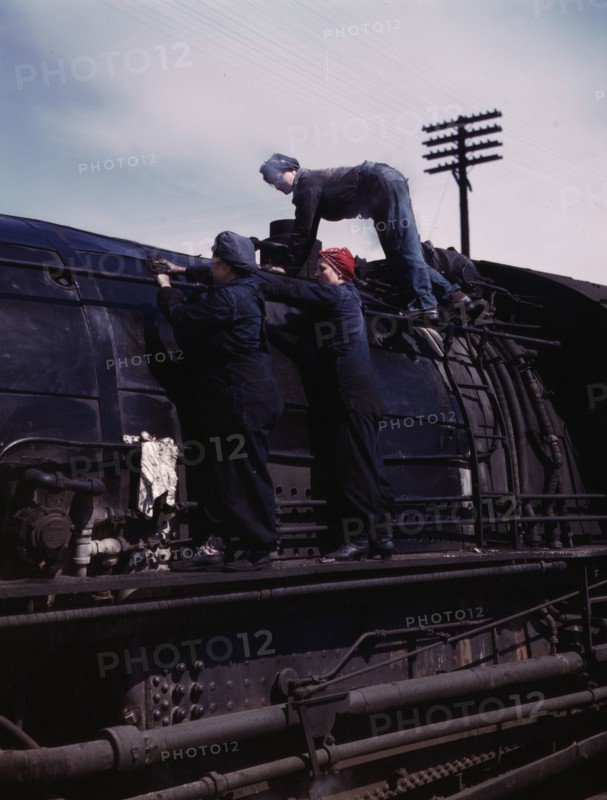 C. & N.W. R.R., women wipers at the roundhouse cleaning one of the giant..., Clinton, Iowa, 1943. Creator: Jack Delano.