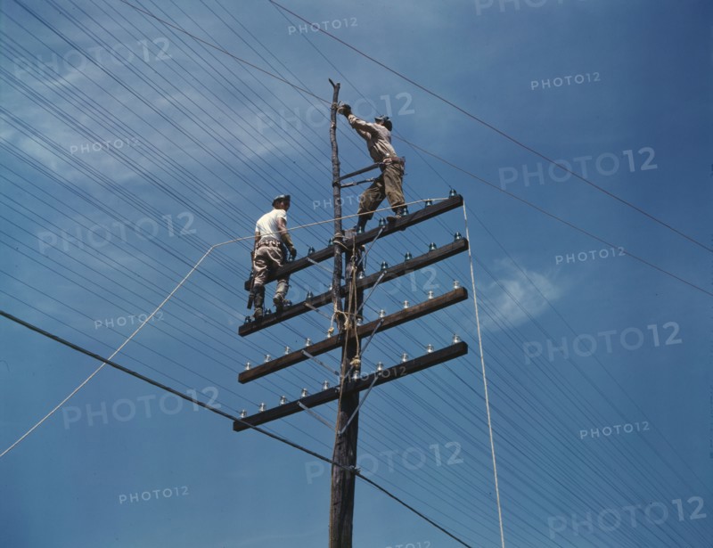 Men working on telephone lines, probably near a TVA dam hydroelectric plant, 1942. Creator: Alfred T Palmer.