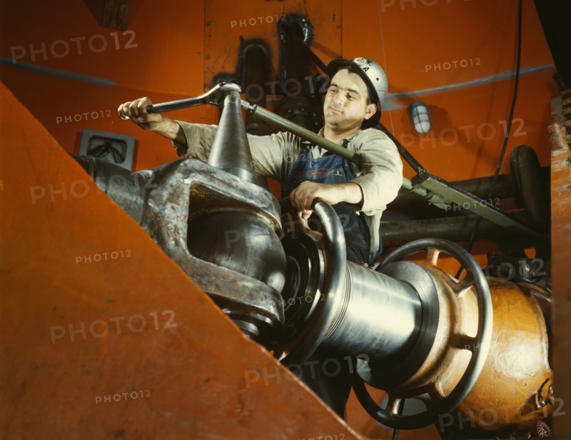Tightening a nut on a guide vane operating seromotor in TVA's..., Watts Bar Dam, Tennessee, 1942. Creator: Alfred T Palmer.