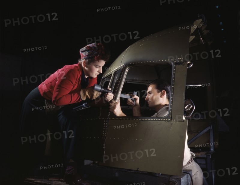 Riveting team working on the cockpit shell of a...Douglas Aircraft Co., Long Beach, Calif. , 1942. Creator: Alfred T Palmer.