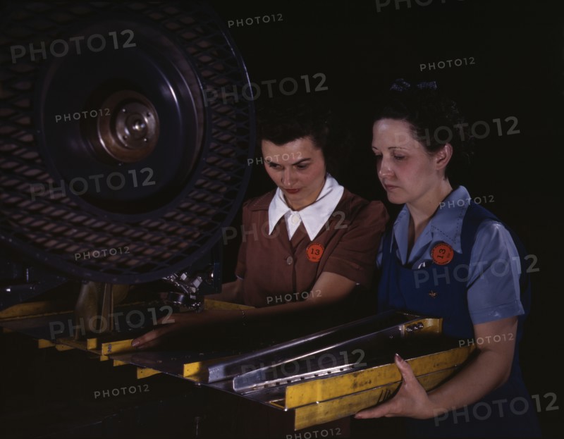 Punching rivet holes in a frame member for a B-25 bomber...North American Aviation, Inc., CA, 1942. Creator: Alfred T Palmer.