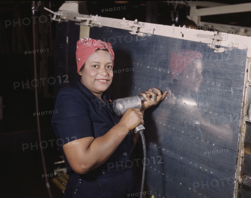 Operating a hand drill at Vultee-Nashville, woman is working on a "Vengeance" dive..., Tenn., 1943. Creator: Alfred T Palmer.