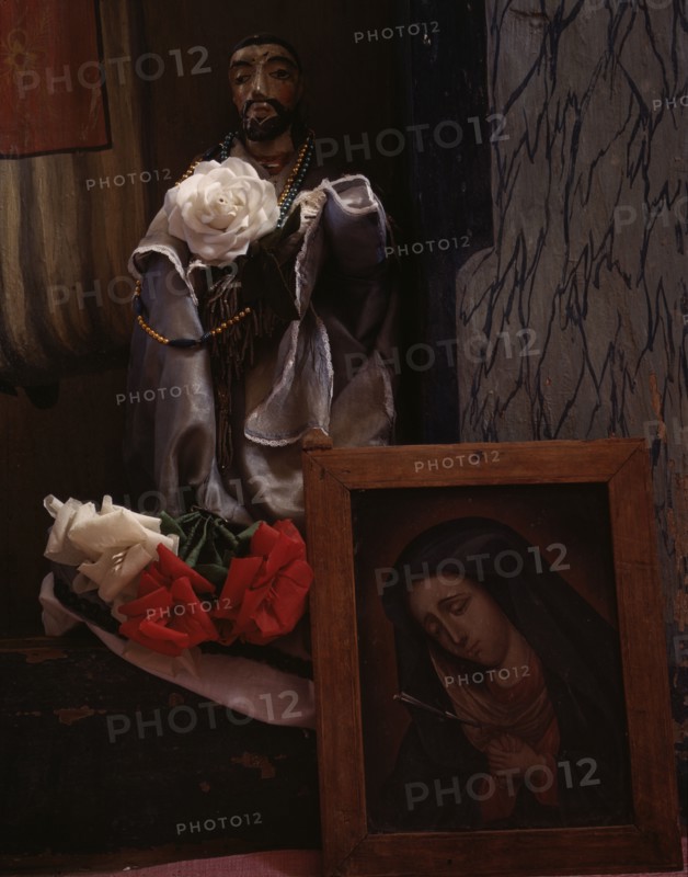 A Santo bulto and a painting of the Dolorosa in the church, Trampas, New Mexico, 1943. Creator: John Collier.