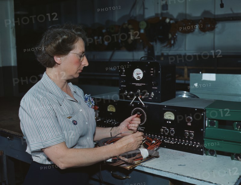 Working with the electric wiring at Douglas Aircraft Company, Long Beach, Calif., 1942. Creator: Alfred T Palmer.