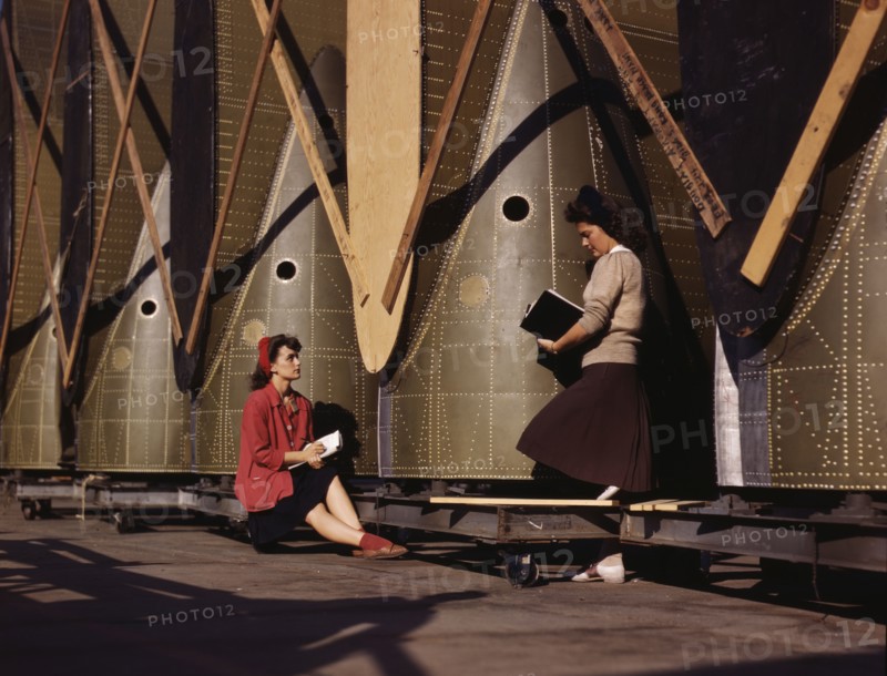 Girl inspectors at the Long Beach, Calif., plant of Douglas Aircraft Company make a careful..., 1942 Creator: Alfred T Palmer.