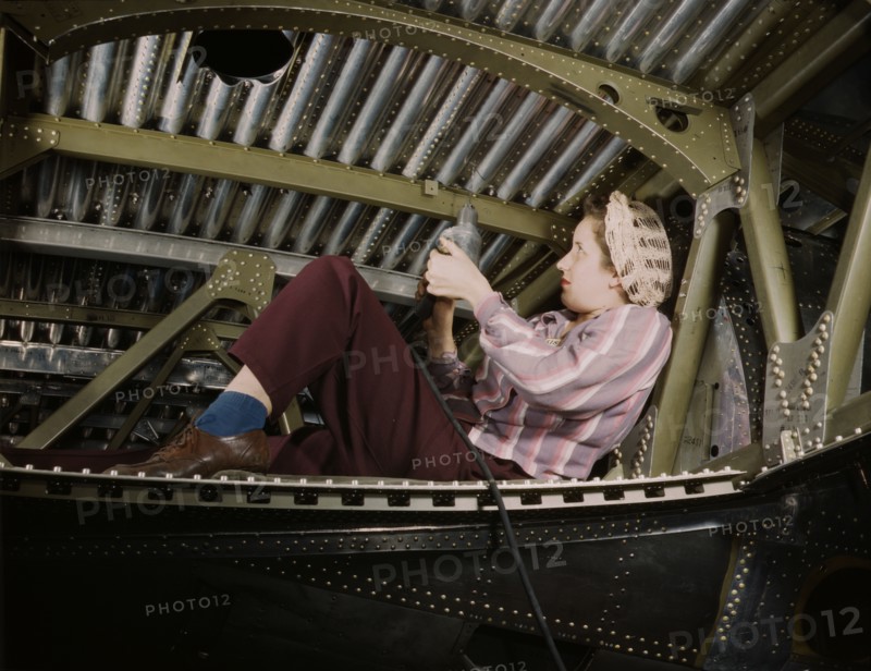 An A-20 bomber being riveted by a woman...Douglas Aircraft Company plant at Long Beach, Calif., 1942 Creator: Alfred T Palmer.
