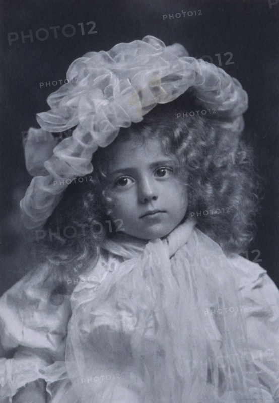 Portrait of little girl in frilly hat, c1900.