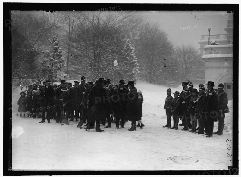 Group outside White House in snow, between 1913 and 1918.