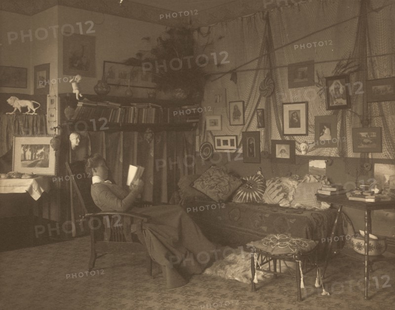 Miss Foster, faculty at Carlisle Indian School, full length, reclining in chair, reading a book, between 1901 and 1903.
