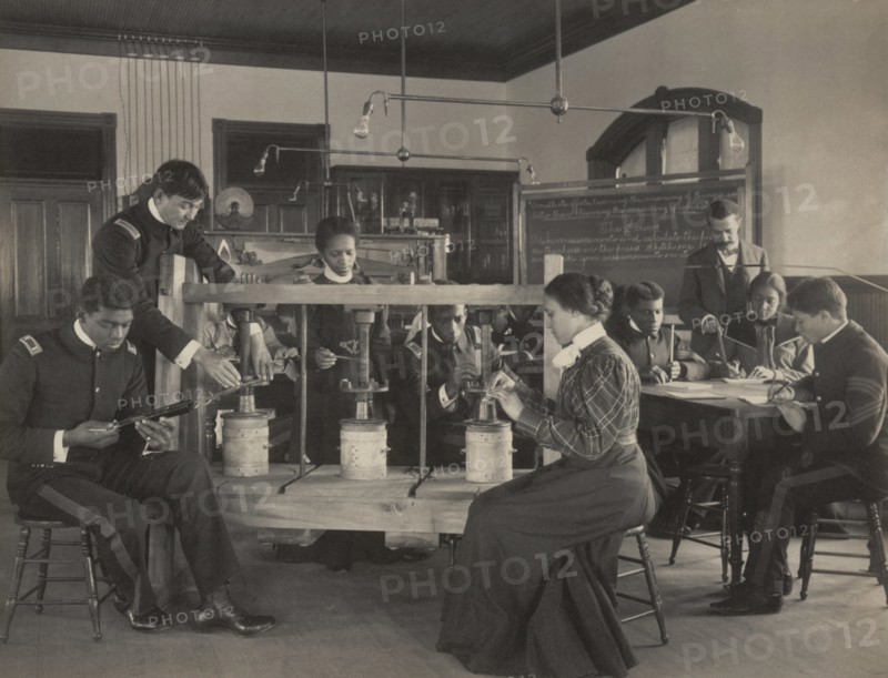 The cheese press screw - students studying agricultural sciences, Hampton Institute, Hampton, Virginia, 1899 or 1900.