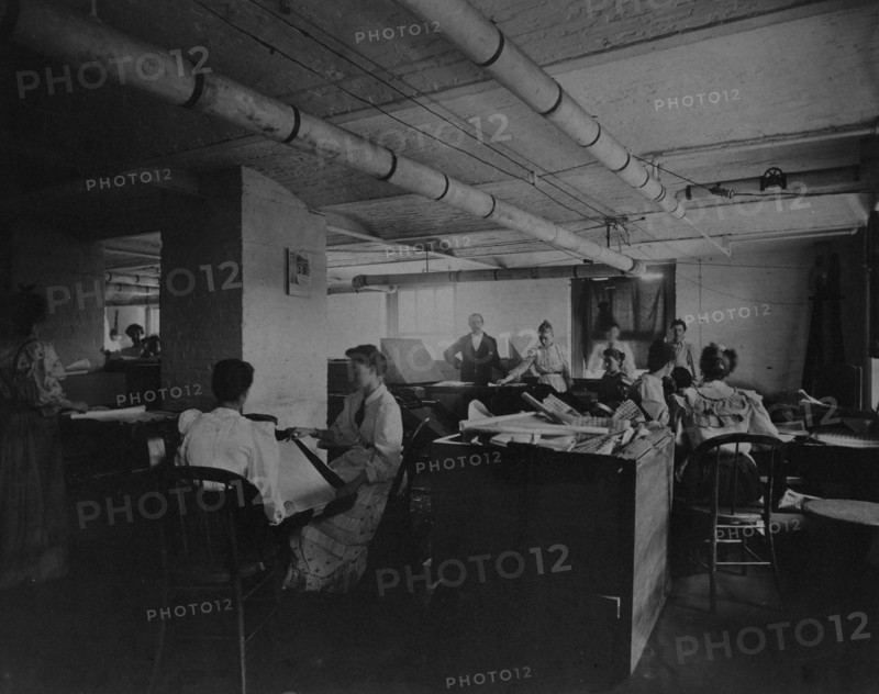 Workers taking mucilaged sheets of postage stamps from the drying box in the gumming..., c1895. Creator: Frances Benjamin Johnston.