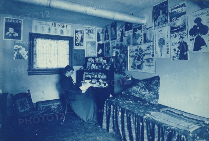 Frances Benjamin Johnston seated at a desk in her studio/office, with adverstising..., c1896. Creator: Frances Benjamin Johnston.