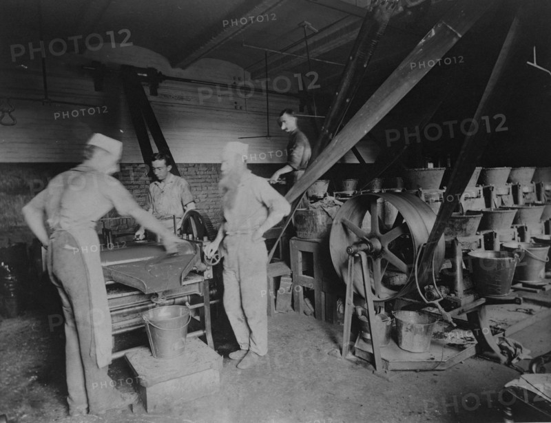 Workers grinding and processing the ink used to print paper money at the Bureau of Engrav..., c1890. Creator: Frances Benjamin Johnston.