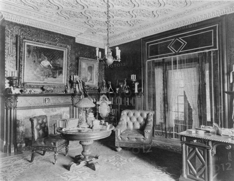 Room with plasterwork ceiling, fireplace, and circular table.., Greenwich, Connecticut, 1908. Creator: Frances Benjamin Johnston.