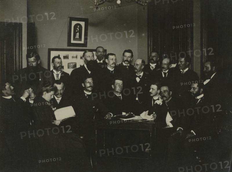 Frances Benjamin Johnston, seated in profile at left, group portrait with 18..., c1880 - 1900. Creator: Frances Benjamin Johnston.