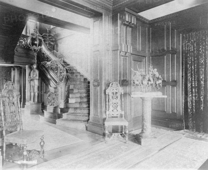 Hall and stairway, with suit of armor at left, and statue of cow..., Greenwich, Connecticut, 1908. Creator: Frances Benjamin Johnston.