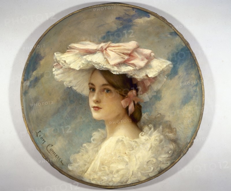 La charlotte d'Alphonsine, 1905. Woman in hat decorated with ribbons.