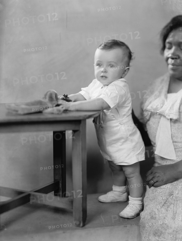 Vincent P. Aherns, Portrait, 1933. White child with African American nanny.