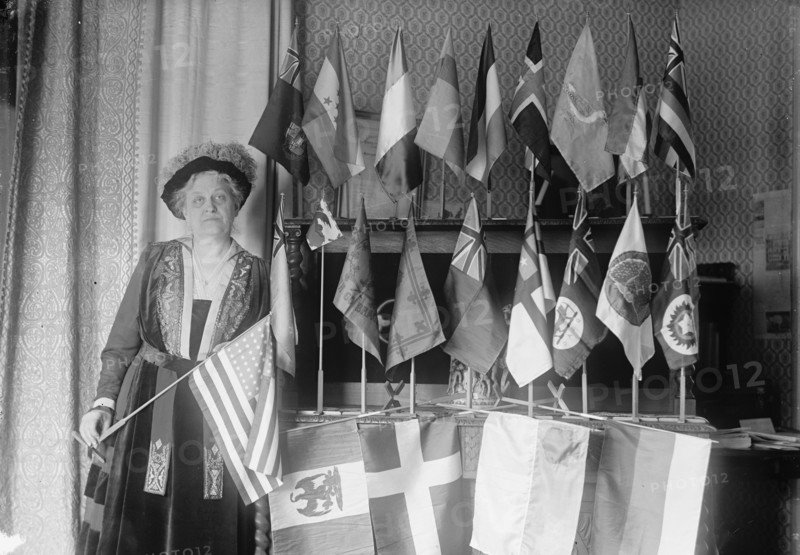 Mrs. Carrie Chapman Catt with Flags of 22 Nations, 1917. Creator: Harris & Ewing.