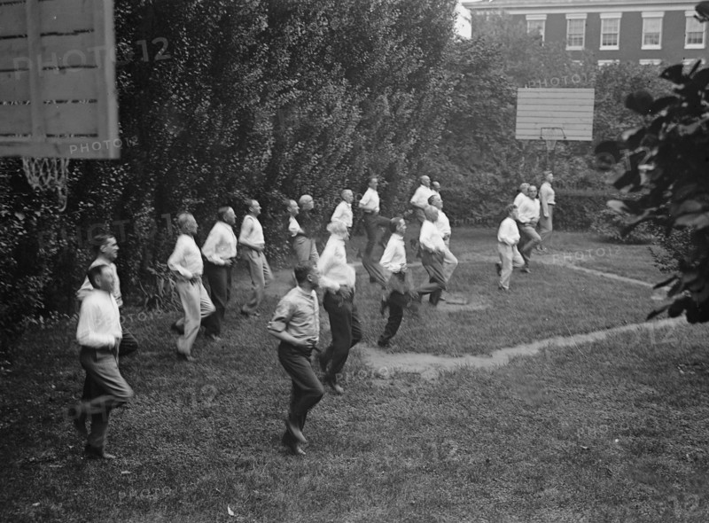 Camp, Walter, I.E, Exercise School - Cabinet Officials Exercising with Other Govt. Officials, 1917 or 1918.