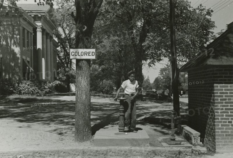 Drinking fountain on the county courthouse lawn, Halifax, North Carolina, 1938-04. Creators: Farm Security Administration, John Vachon.